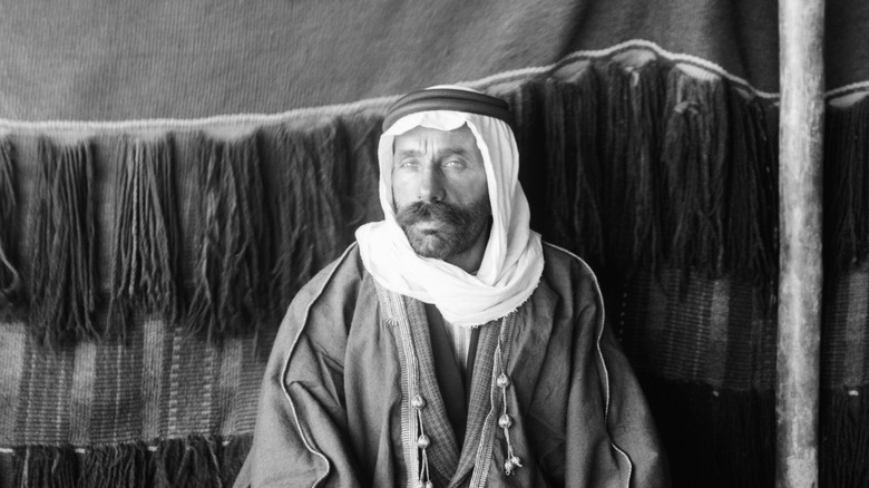 Sultan Al-Atrash sitting down in headscarf 