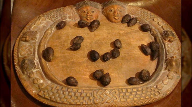 Ifa divining tray with pine nuts