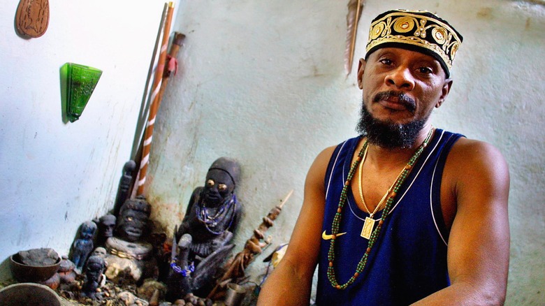 Cuban Babalawo with shrine