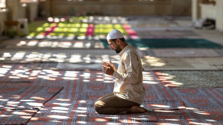 Muslim man praying in mosque