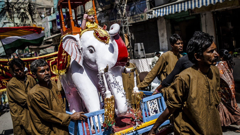 Jains parading with elephant statue