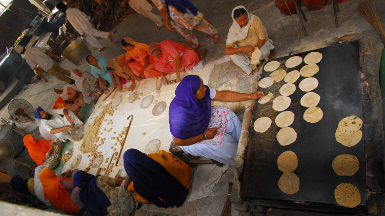 Sikh women preparing roti