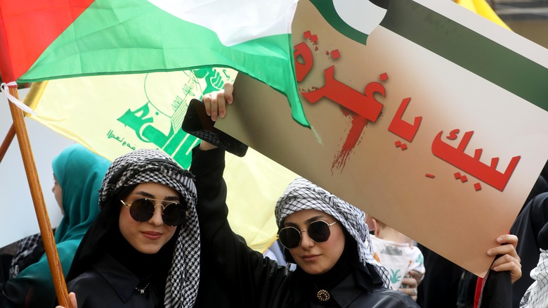 Demonstrators raising Palestinian Hezbollah flags