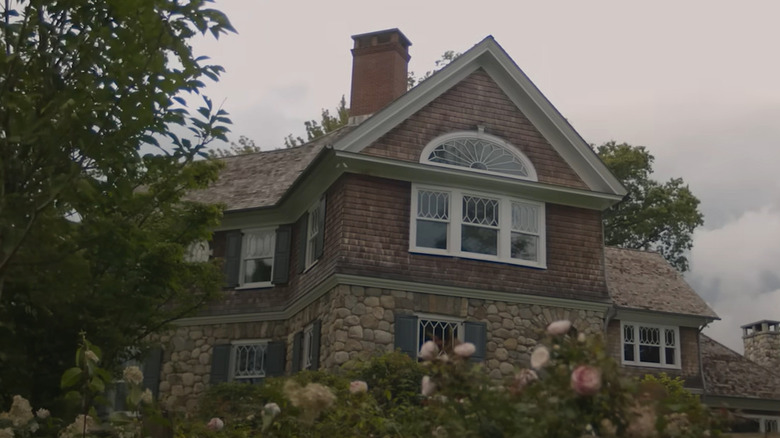 The house, as depicted in "The Watcher," looms over the lawn