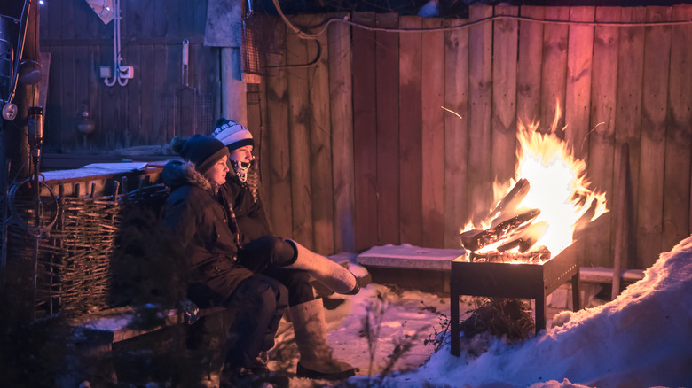 people sitting by fire