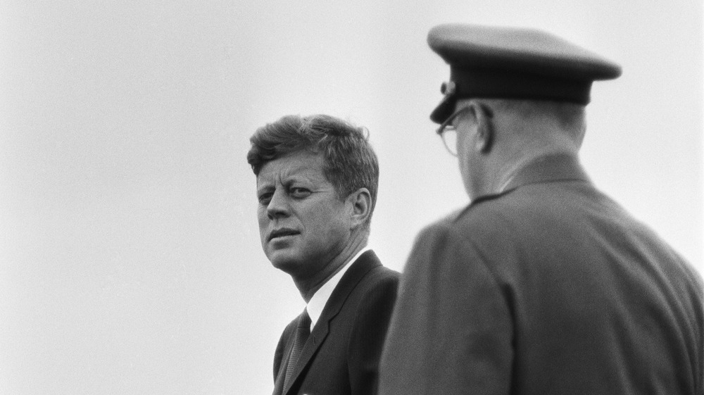 John F. Kennedy waiting with a guard to be taken to speak to the people of Berlin
