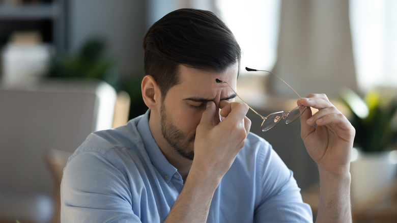 Man rubbing his eyes