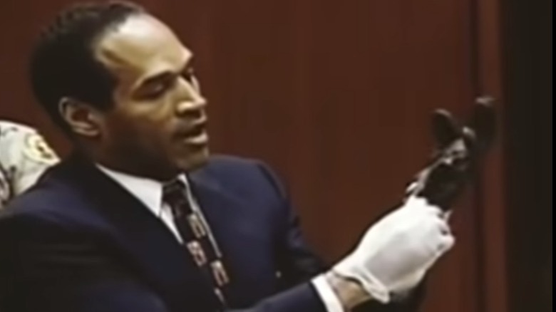 O. J. Simpson tries on glove  