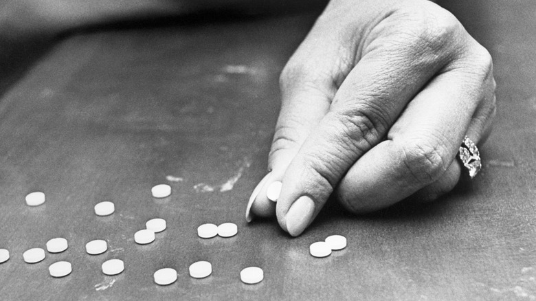 hand with thalidomide pills