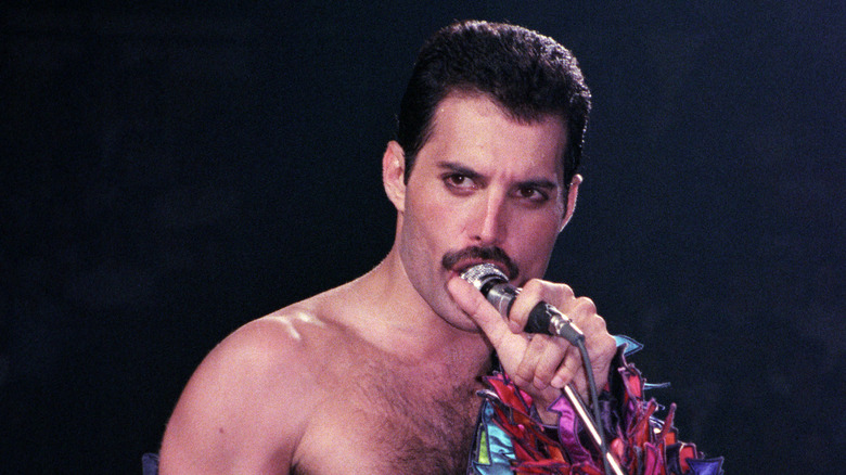 Freddie Mercury singing into microphone