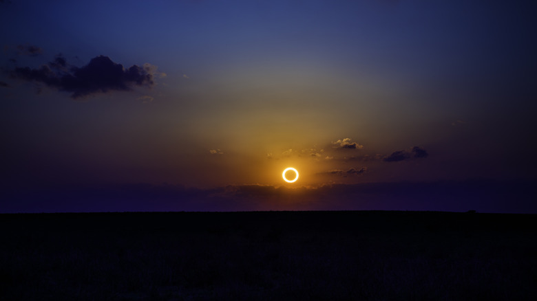 Annular eclipse low on horizon