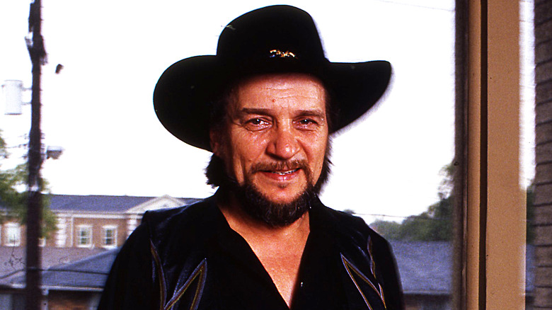 Smiling Waylon Jennings wearing cowboy hat