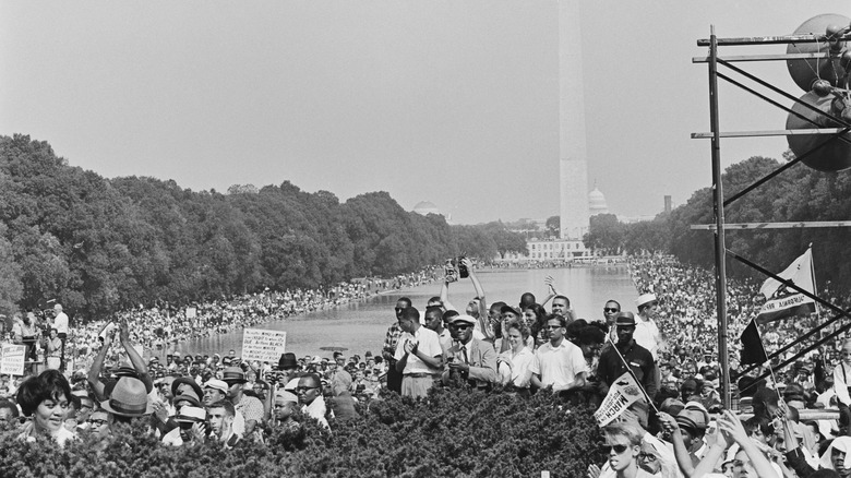 Big crowd in front of reflecting pool monument