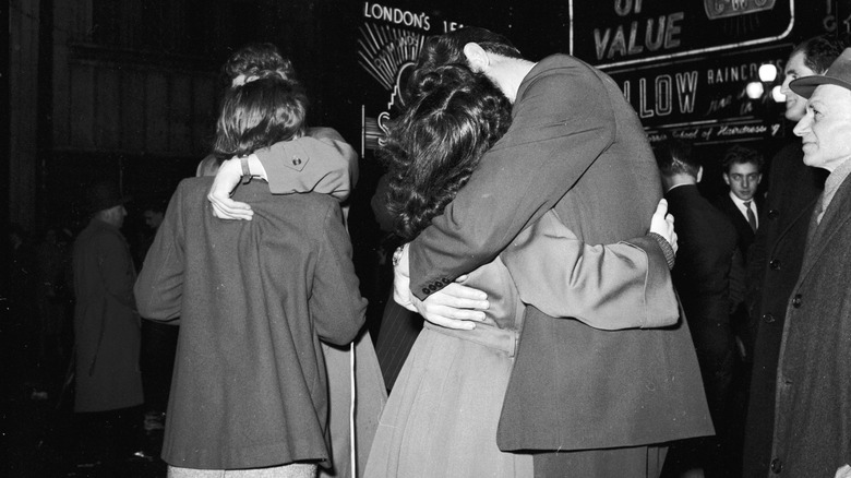 Revellers in London's Piccadilly Circus kissing