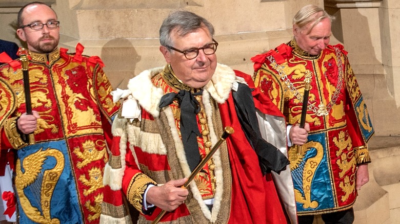 Earl Marshal (center) carries staff