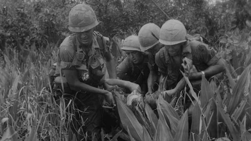 soldiers carry a wounded comrade