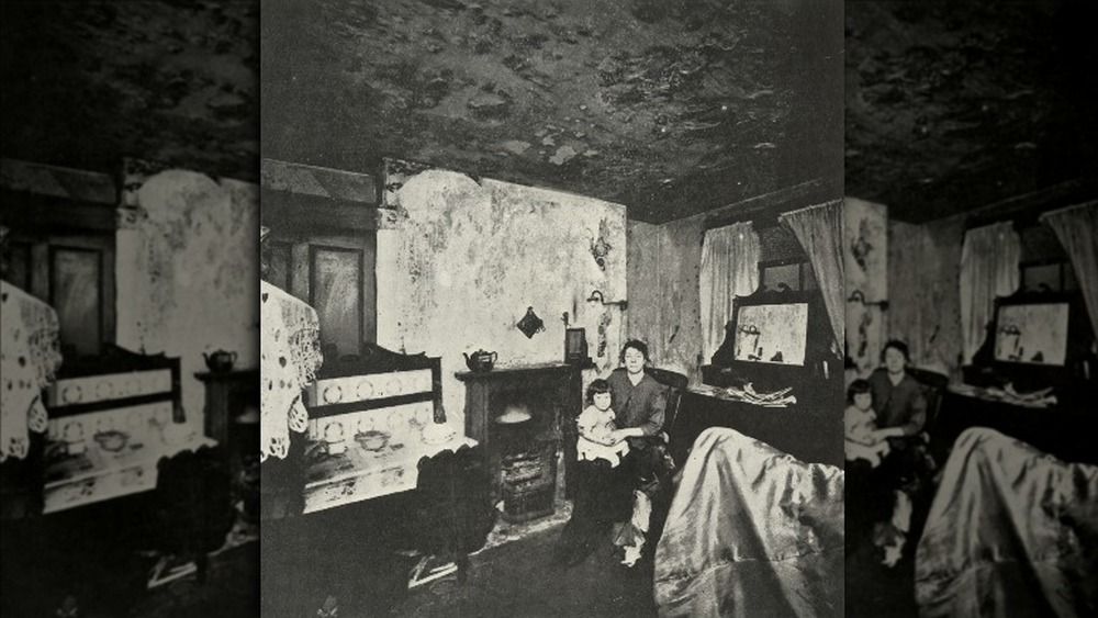 Woman and child sitting in slum housing