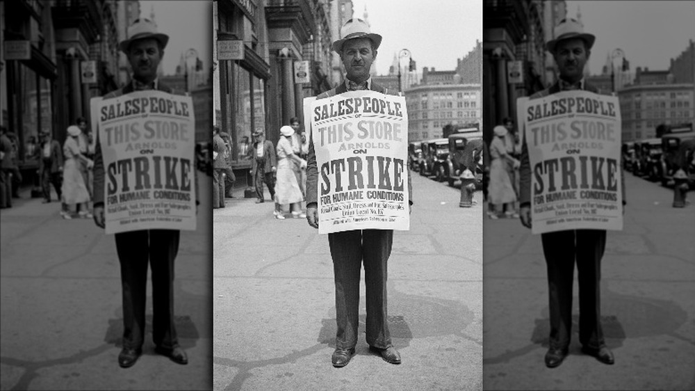 Union member posing for photo holding paper sign