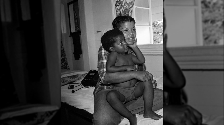 Leslie Wilson holds her son Jakari in a hotel after escaping Jonestown