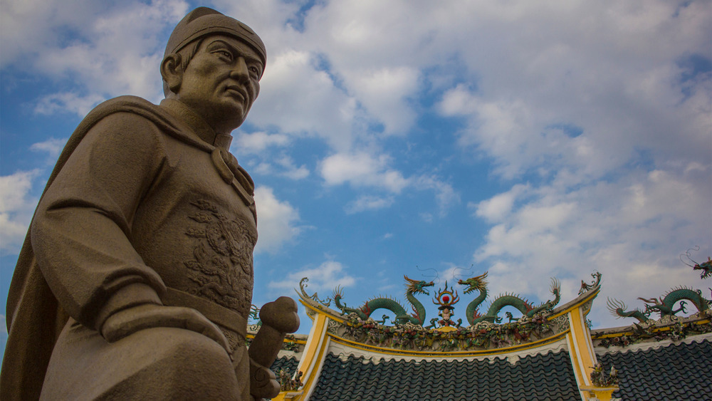 Stone statue of Zheng He with blue sky