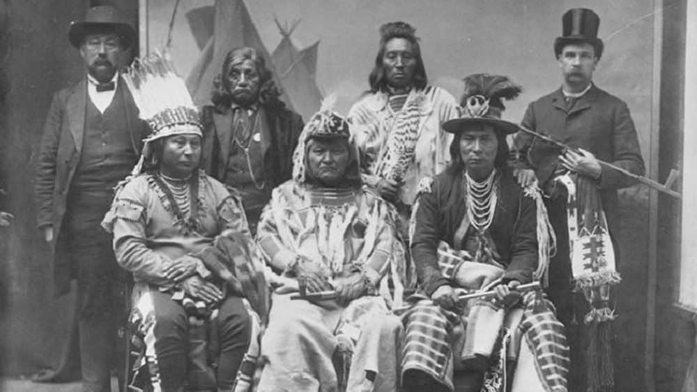 White men posing with Natives