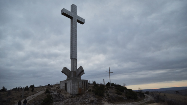 Christian cross under cloudy sky