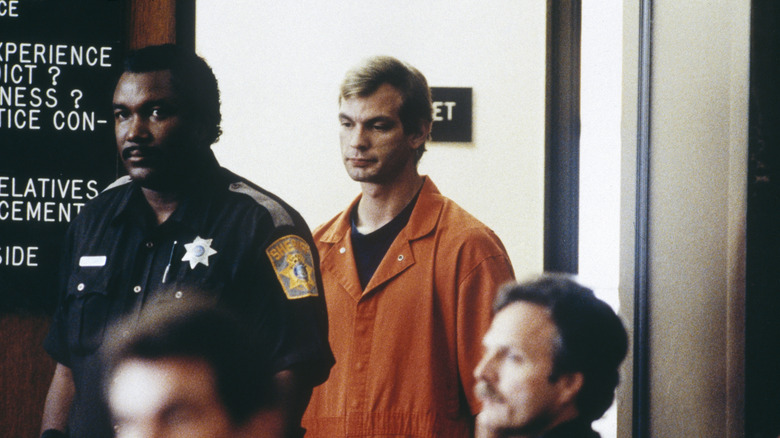 Jeffrey Dahmer in orange jump suit escorted into court