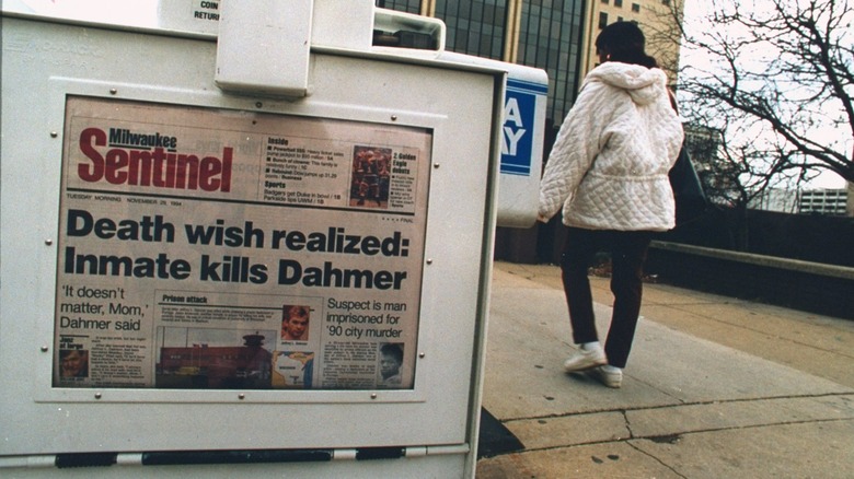 A woman walks past a headline about Jeffrey Dahmer's murder