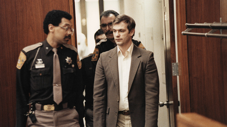 Two policemen escorting Jeffrey Dahmer into court