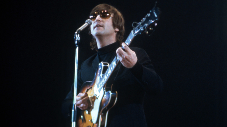 John Lennon playing guitar