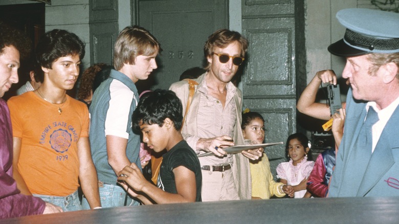 John Lennon signing autographs