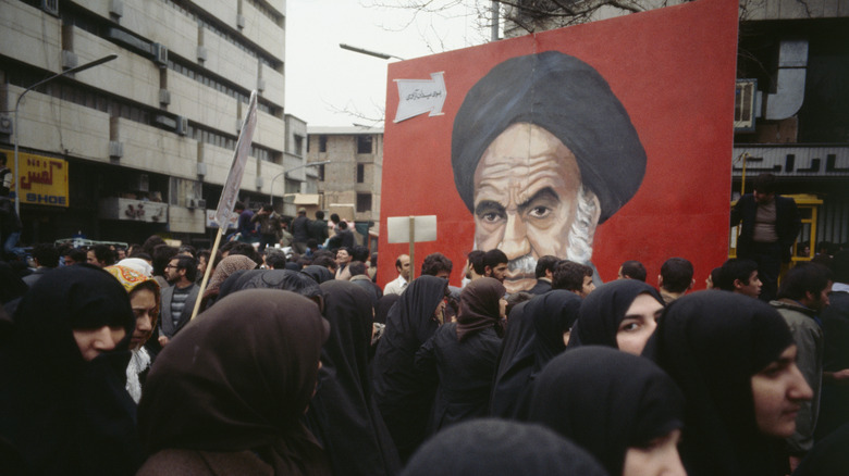 protesters Iran revolution Ayatollah Khomeini poster