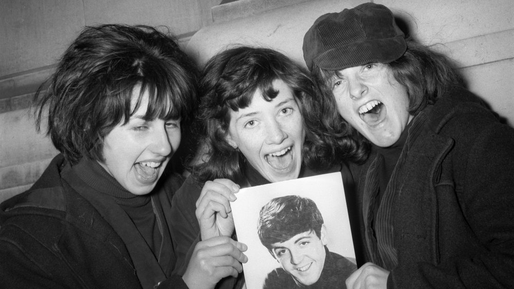 Beatles fans with a portrait of Paul McCartney