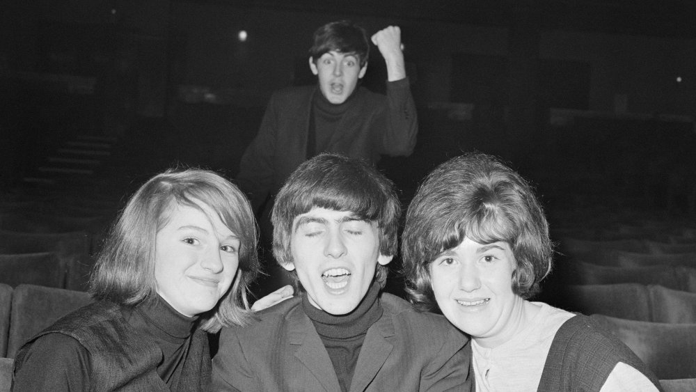 George Harrison and Paul McCartney with fans
