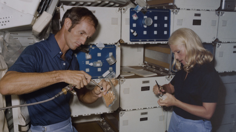 Rhea Seddon working with a male colleague