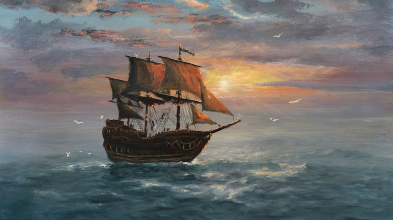 painting of sailing ship at sunset