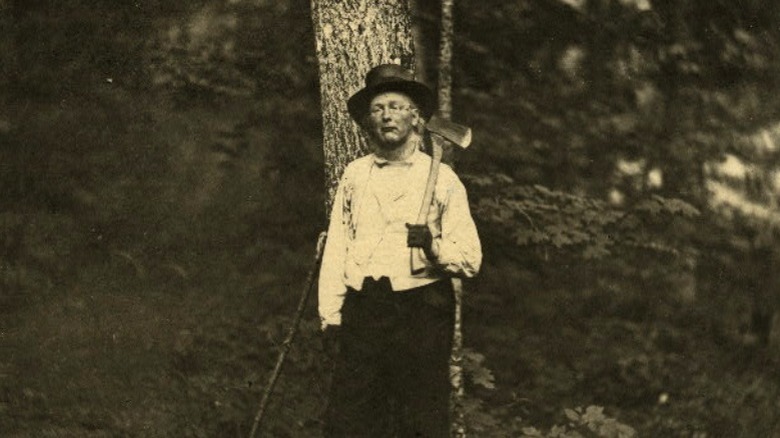 Horace Greeley leaning against a tree