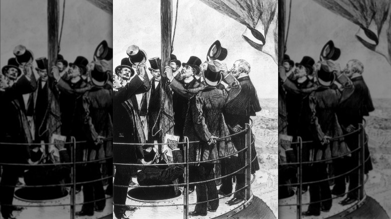 March 1889: French engineer Gustave Eiffel (1832 - 1923) with some dignitaries on the small platform at the tip of the Eiffel Tower during the Dedication ceremon