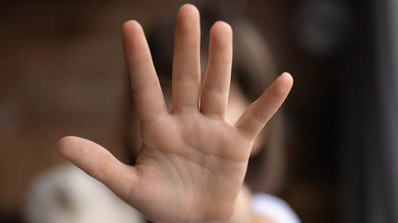 Girl's hand in stop position