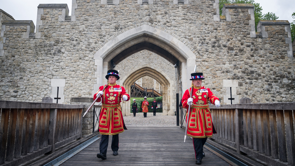 beefeater guards walking over bridge