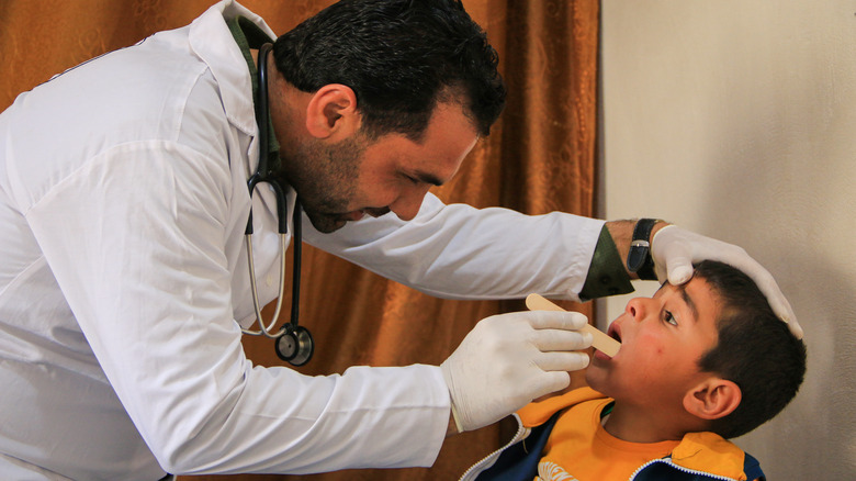 doctor examining a child in Syria