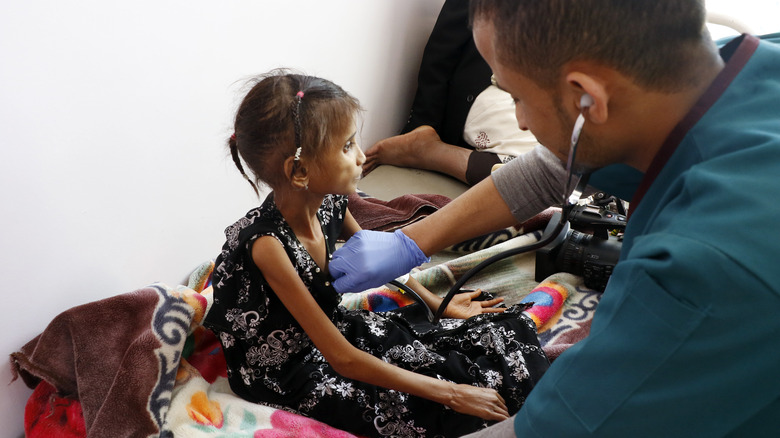 doctor examining a child in Yemen