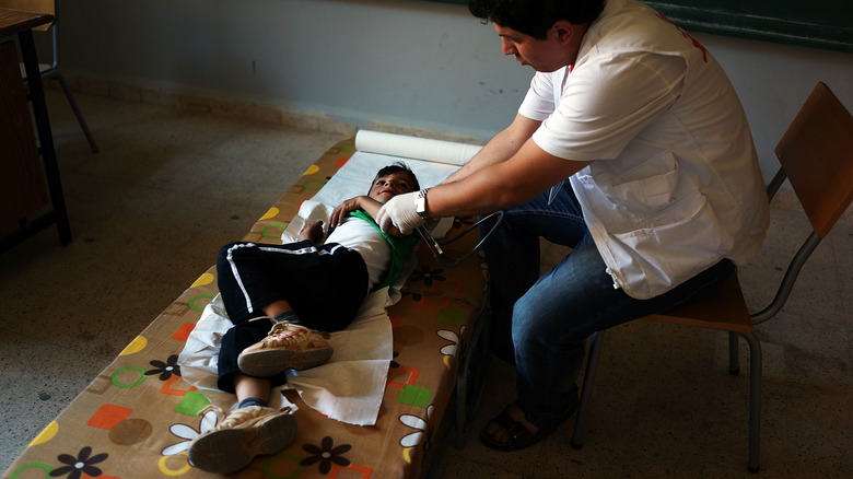 doctor examining a young patient