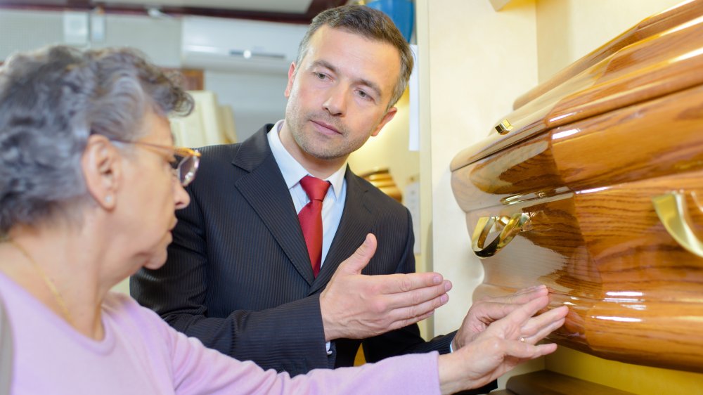 Funeral director showing coffin