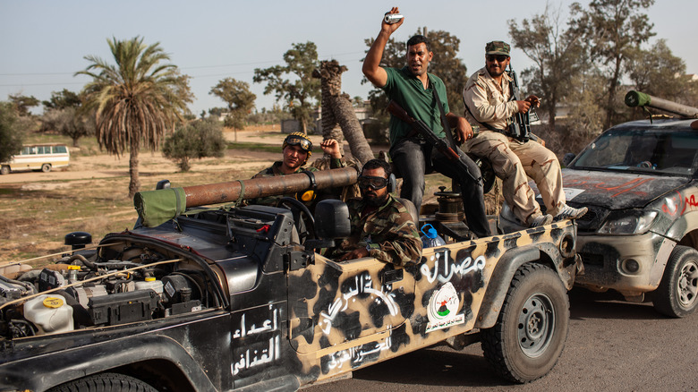 Militiamen of the Al Borkan brigade celebrate the fall of Libya's ex-strongman Muammar Gaddafi