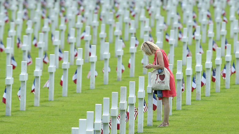 woman standing at graves of U.S. soldiers