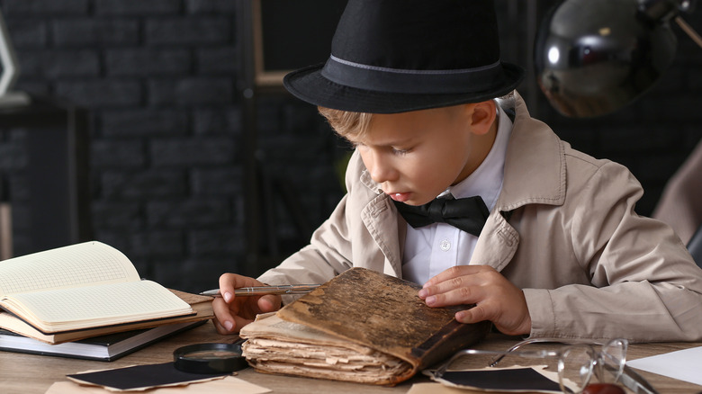 reading child dressed as private investigator