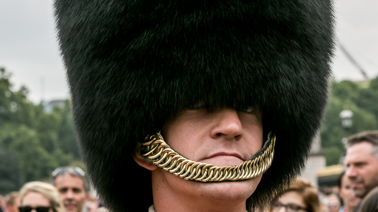 Guardsman face close up wearing black fur hat