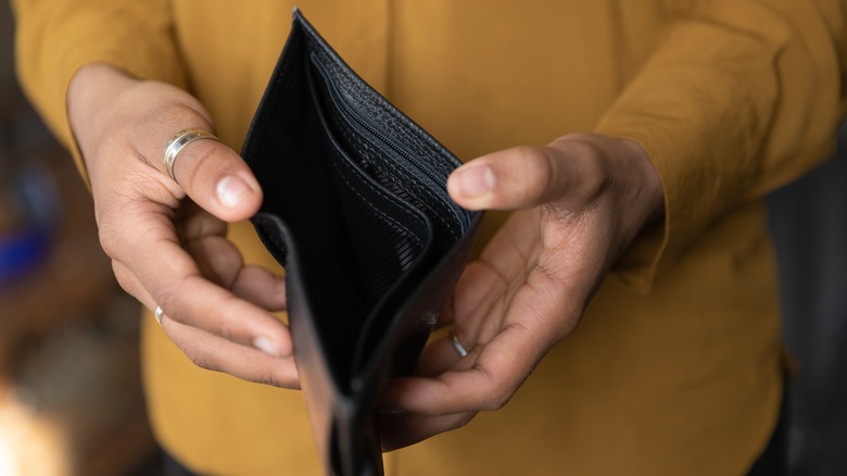 Man holding empty wallet