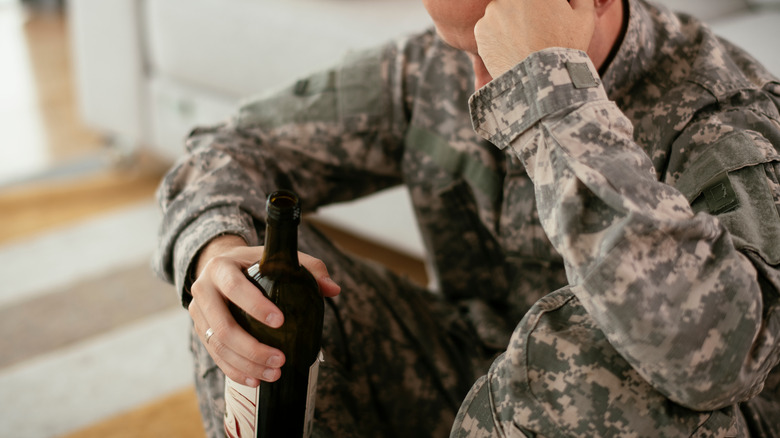 Soldier in fatigues drinking